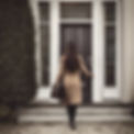 show the back of a brunette woman notary carrying a breifcase and knocking on the door of