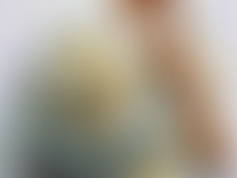 A clear glass jar filled with a mix of 1 cup Epsom salt, 1 tbsp dried daisies, 1 tsp dried lemon balm, and 5 drops grapefruit oil. The Epsom salt is white and crystalline, with delicate dried yellow-and-white daisy petals and dried small green lemon balm leaves scattered through it. The jar is open, with a minimal wooden spoon resting beside it.