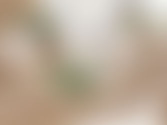 Close-up view of a compact recycled glass candle holder on a wooden table