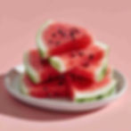 a plate full with slices of fresh watermelon on a pink background