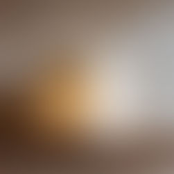  a delicate translucent handmade paper mâché table lamp with a softly squared, block-like shape and rounded edges, crafted from thin off-white paper mâché. 