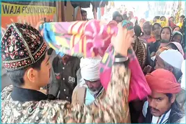 Khwaja Garib Nawaz Khadim helping devotees near Ajmer Sharif Dargah charity area