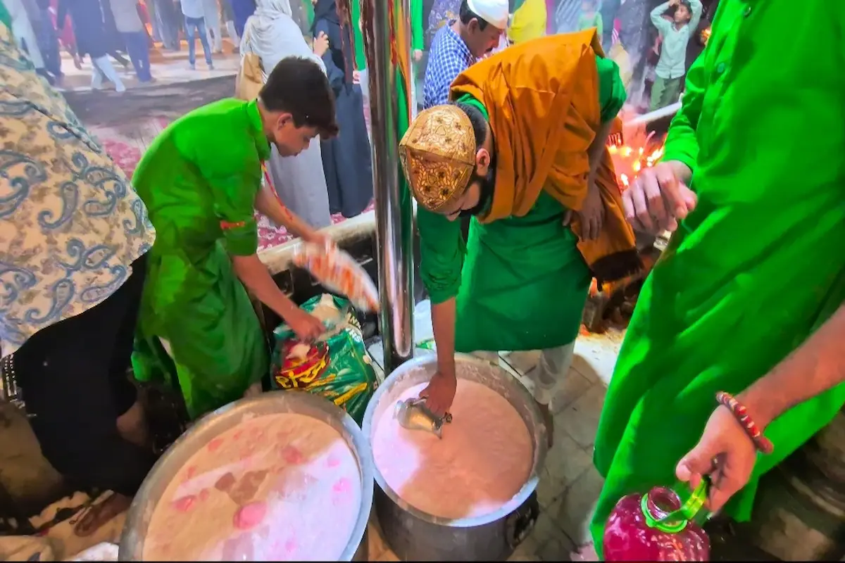 Visitors sitting quietly in the courtyard feeling spiritual calm in Ajmer