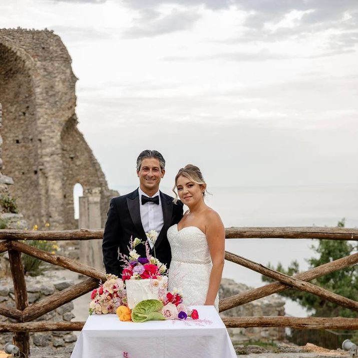 Bride and groom with wedding cake on Amalfi Coast terrace