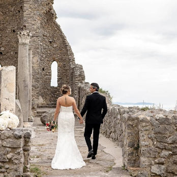 Bride and groom walking through historic ruins on Amalfi Coast