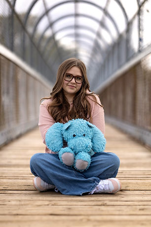 Teige's Journeys Hippo and The Founder of Teige's Journey - sitting criss cross
