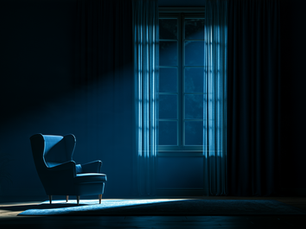 An empty armchair in a dark room with cold blue light falling through a curtained window