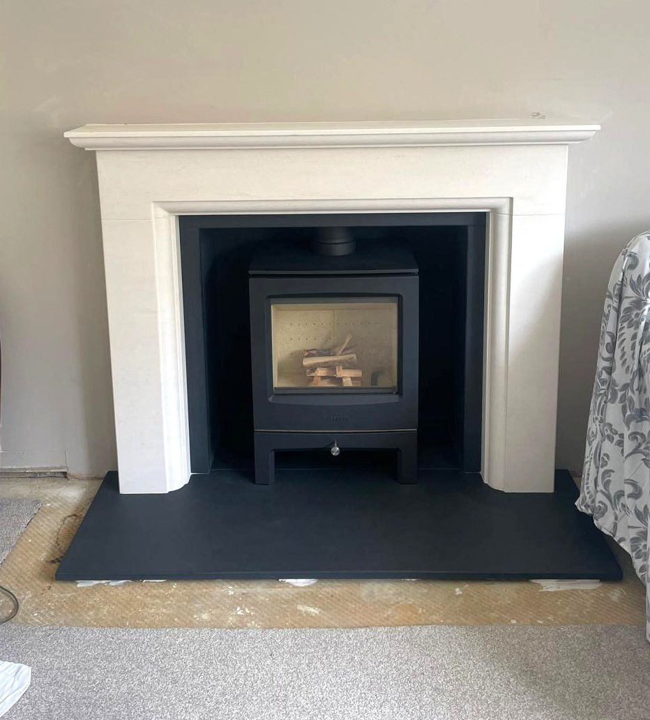Chesneys Sanctuary 5 woodburner, Princeton surround in Veined Limestone, Leathered slate hearth