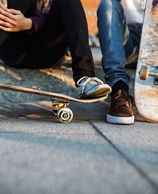 Skateboarders Sitting Together