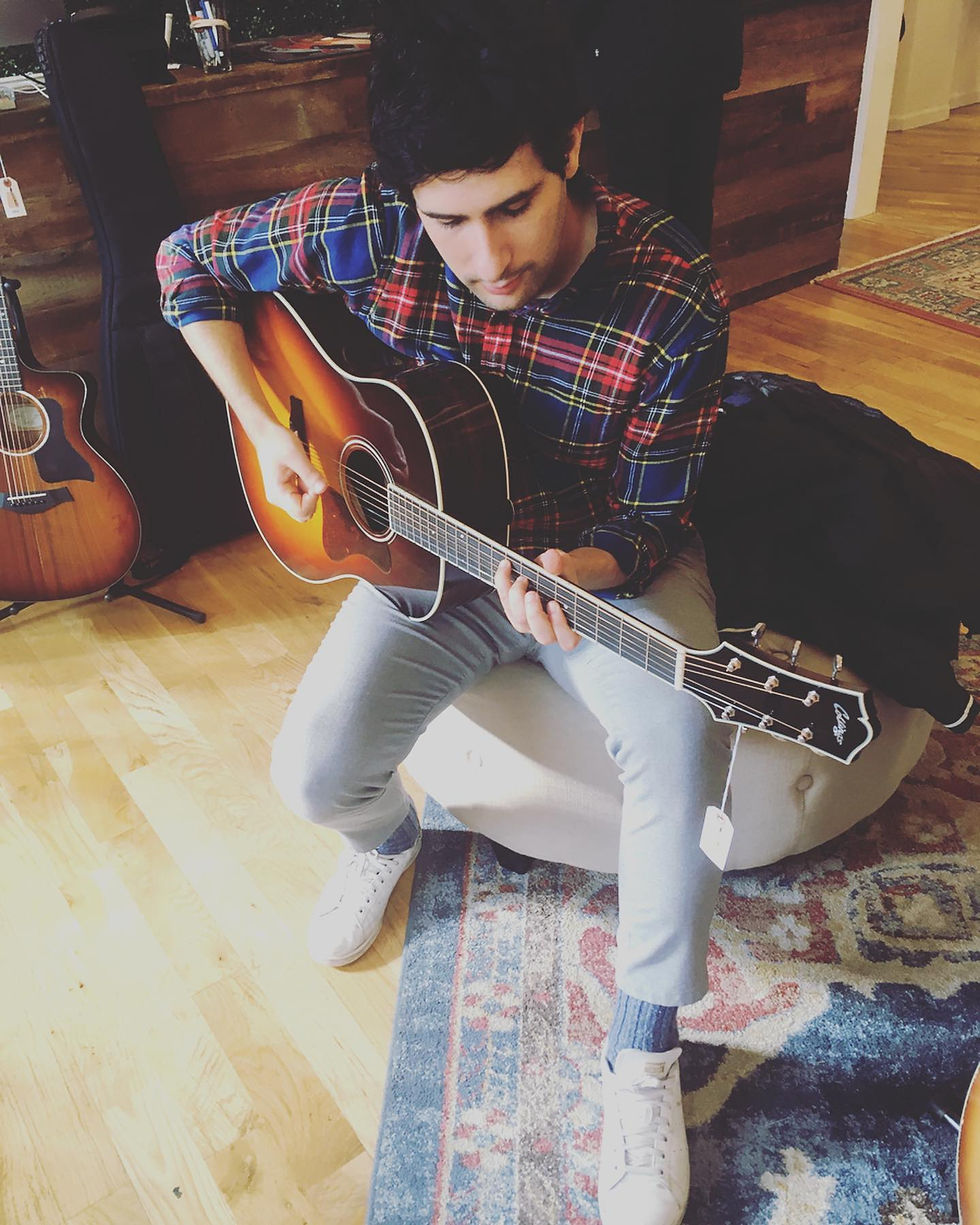 Mick trying out a guitar he can't afford