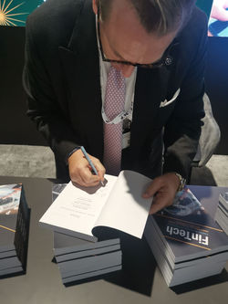 Douglas Arner signing the Fintech book