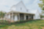 White farmhouse with covered porch