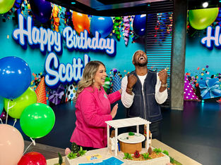 Kristina Lavallee presenting a surprise custom birthday cake to Scott Evans on Access Hollywood and Access Daily.