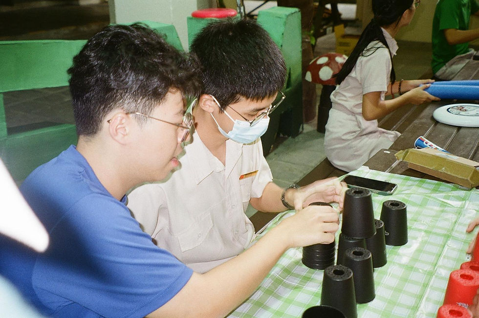 Students participating in a cup stacking game at one of the Athena carnival booths. Hwa Chong Students' Council