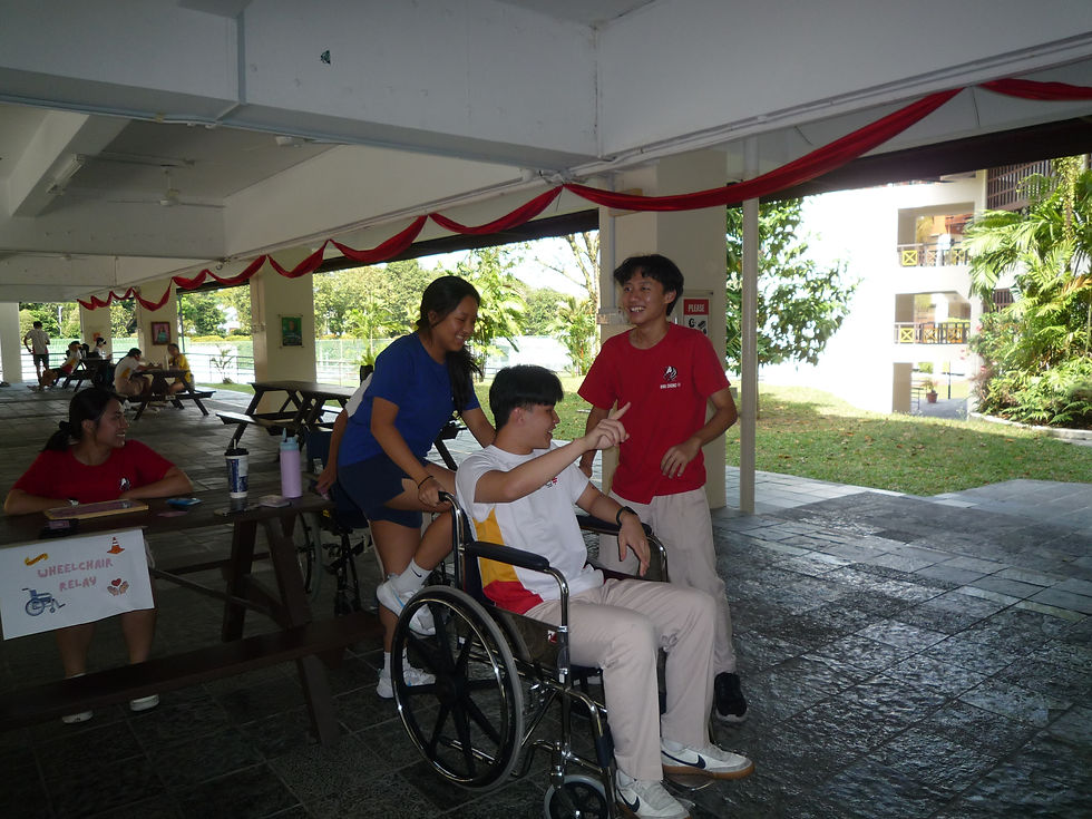 Three students take part in the wheelchair relay. Interact Club/Kayla