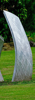 Two piece abstract aluminum sculpture with each arched element mounted vertically and facing one another.