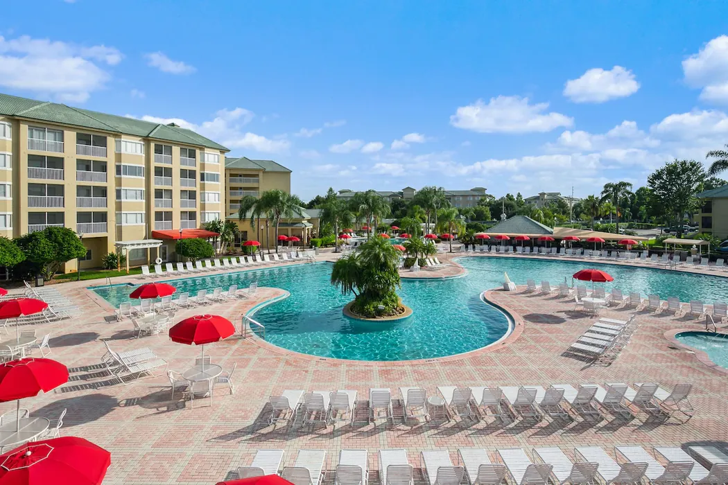Pool with red umbrellas at Silver Lake Resort in Kissimmee