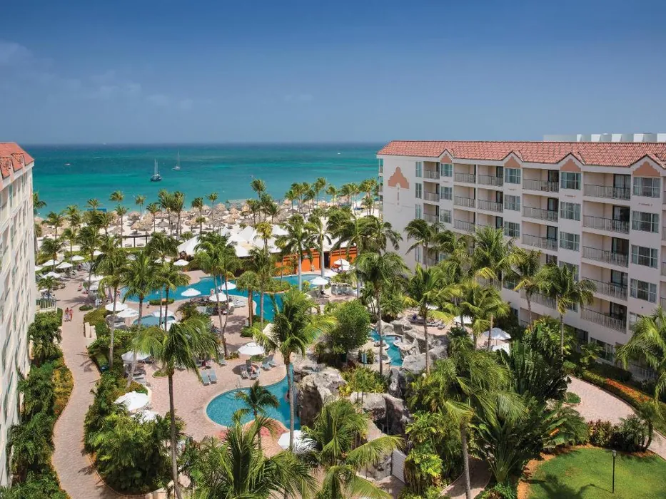 Beachfront Interval International resort with palm-lined pools