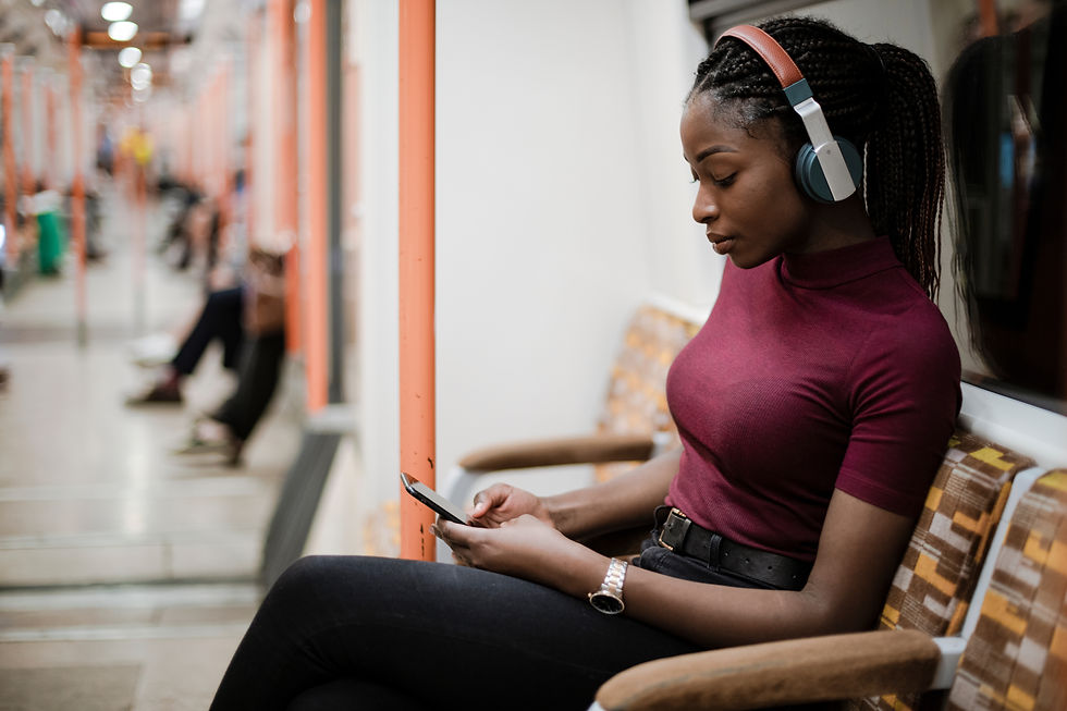 Woman listing to headphones on the subway
