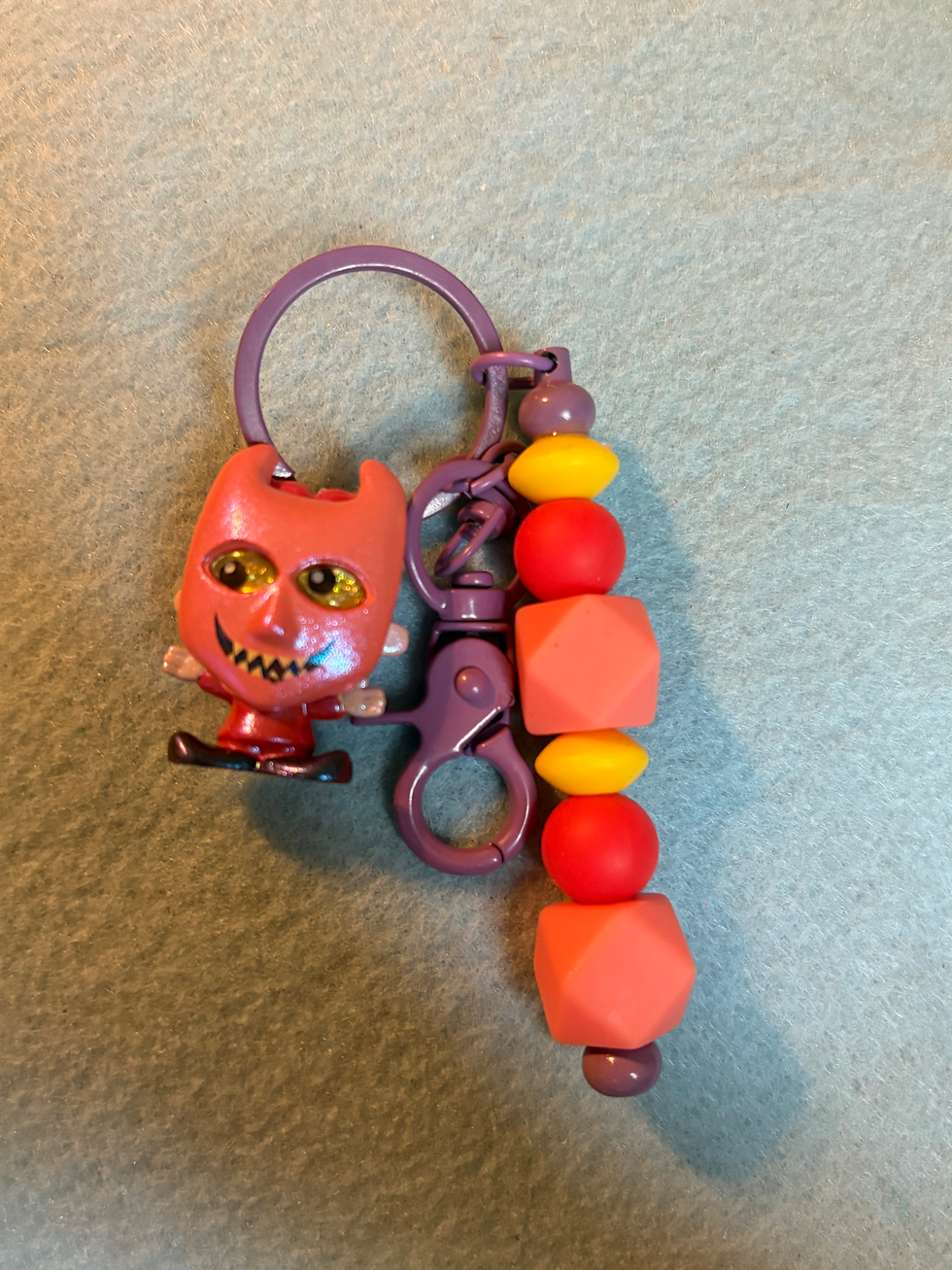 Thumbnail: Red Nightmare Before Christmas Lock keychain with colorful beaded charm.