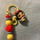 Thumbnail: Snow White character keychain with colorful yellow and red beads.