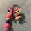 Thumbnail: White cat charm with pink bow and purple beaded lanyard.