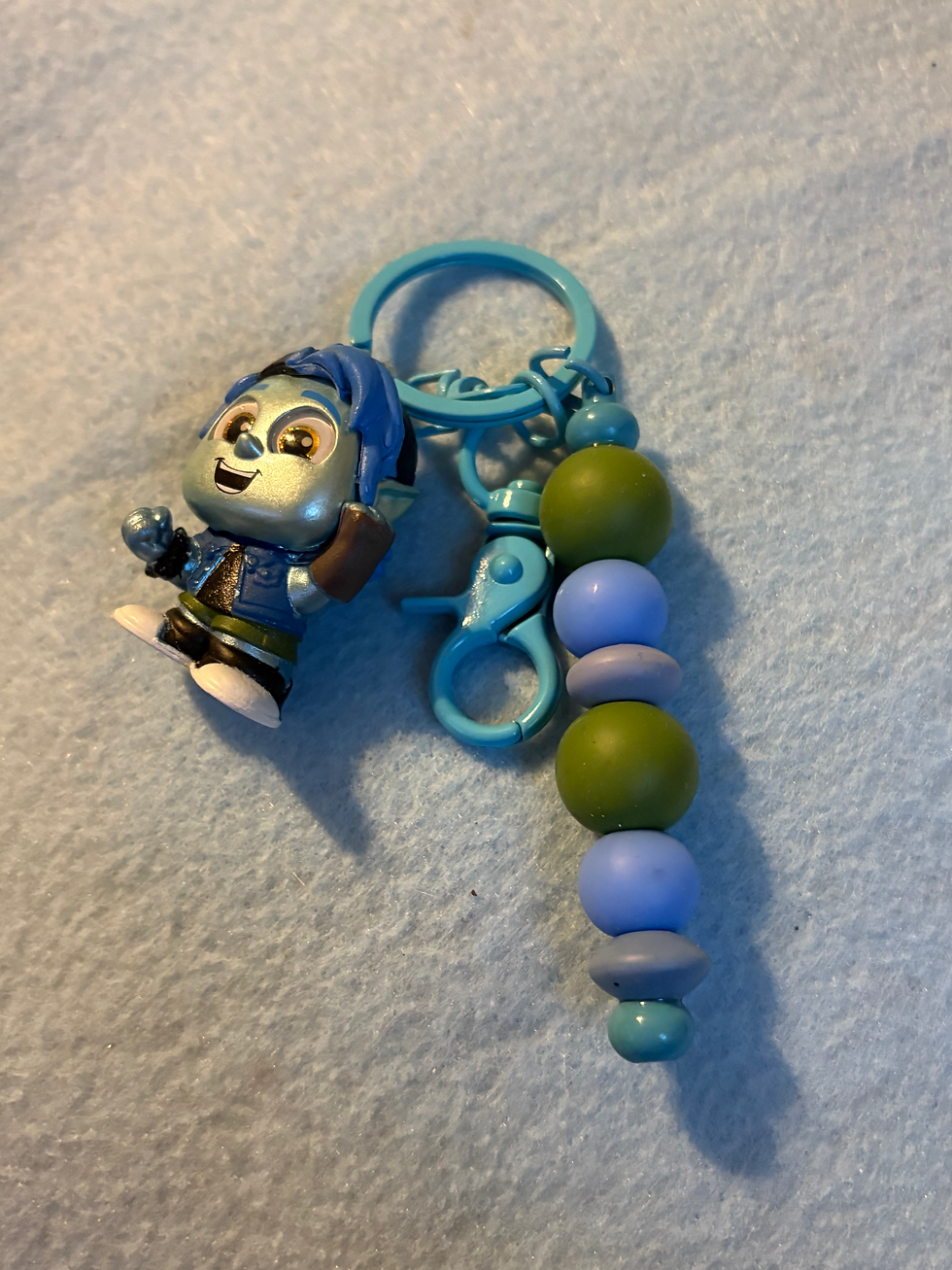Thumbnail: Blue keychain with animated character charm and colorful green, blue beads.