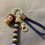 Thumbnail: Snow White figurine keychain with blue braided strap and yellow-blue beads.