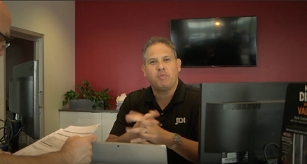 Coach J behind the desk