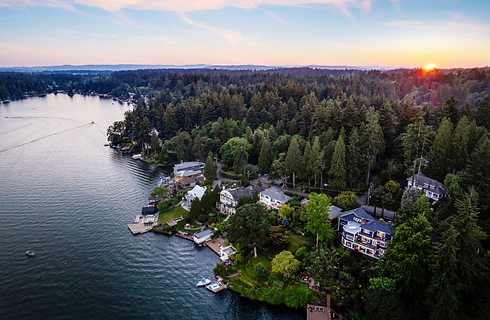 Aerial sunset view of Lake Oswego neighborhood with tree-lined waterfront, Oregon