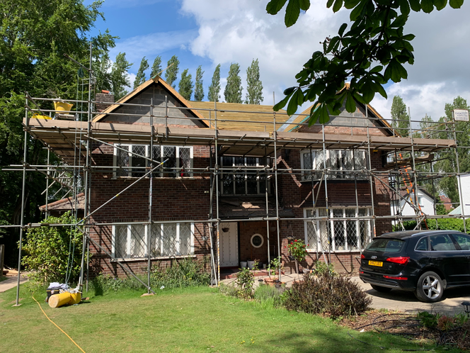 scaffolding over the front of a large house