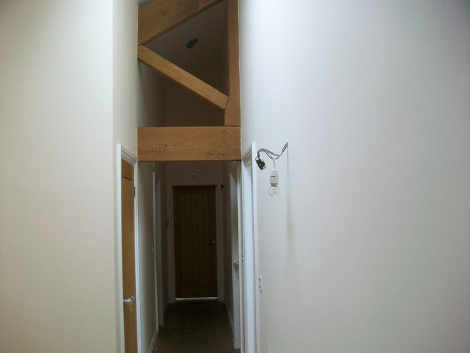 interior of renovated barn with exposed wooden beams