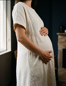 A pregnant woman resting her hands on her belly