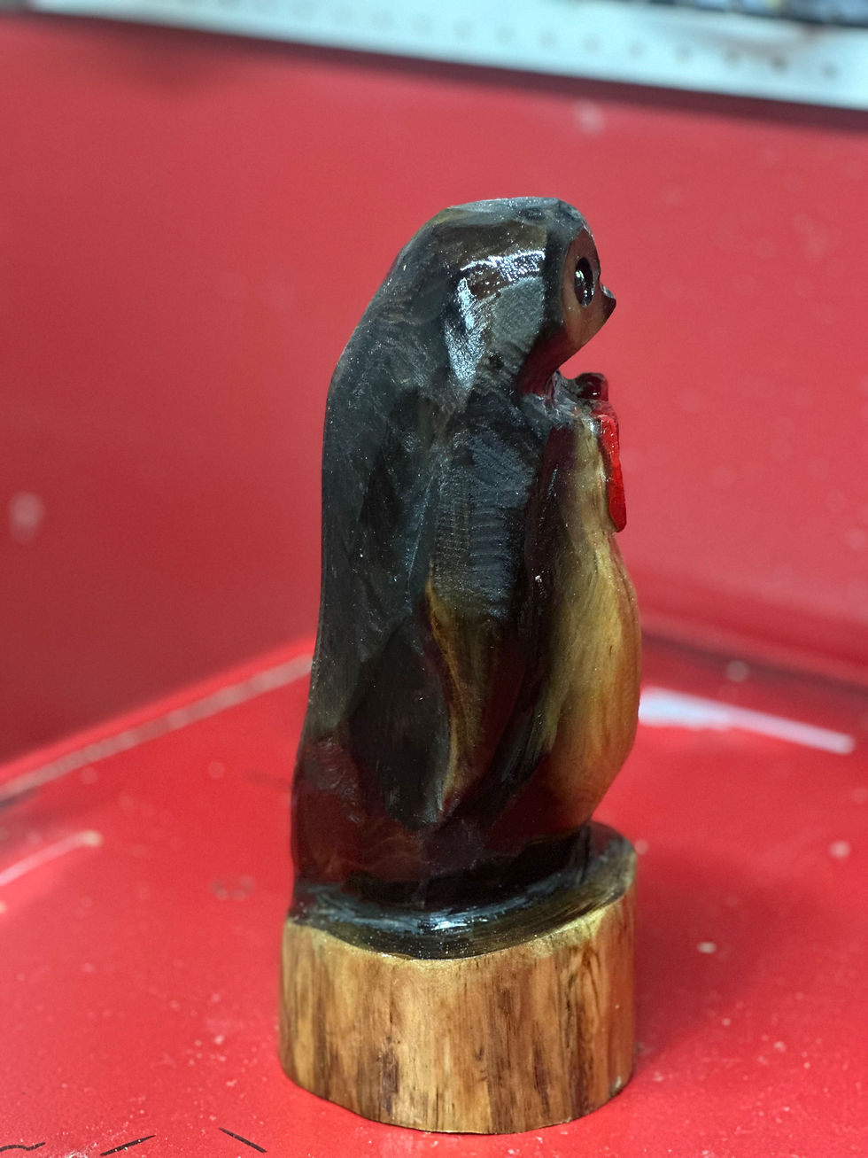 Thumbnail: 11” Red Bow Tie Penguin Chainsaw Carving by Kyra Waits
