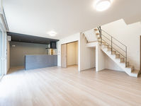 グレーで統一したキッチンと、開放感あふれるリビングのある家