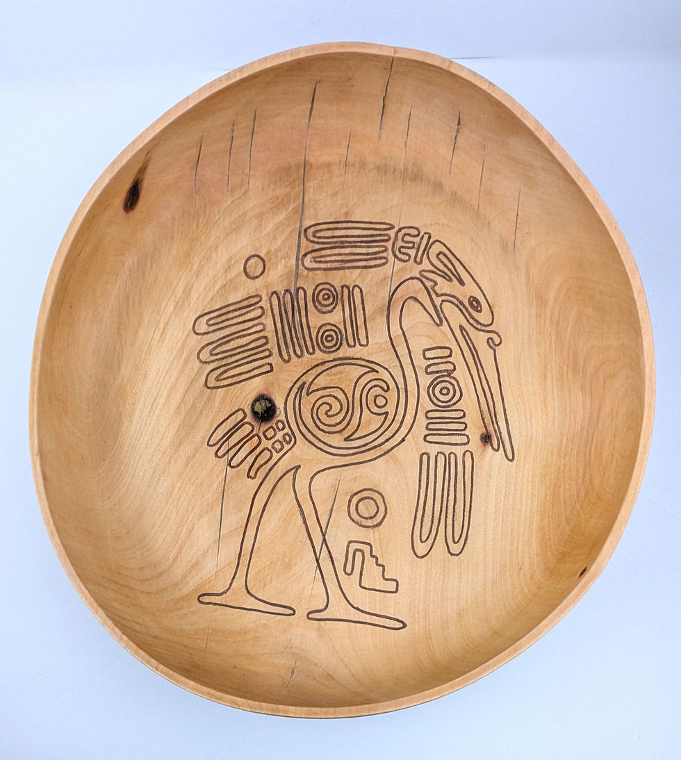 large shallow bowl or platter hand turned from Madrone wood and embellished with a heron design