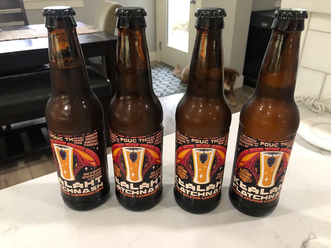 Homebrewed Kolsch with AI generated beer labels sitting on a kitchen counter.