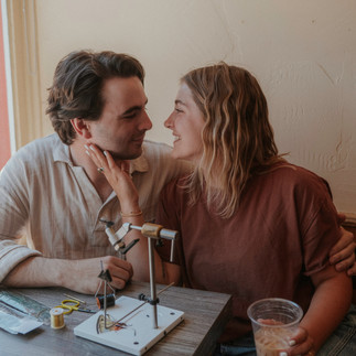 engaged couple tying flies together in t-bar in crested butte colorado