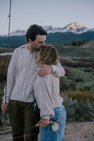 wild and free carefree couple fly fishing together to celebrate their engagement in crested butte colorado