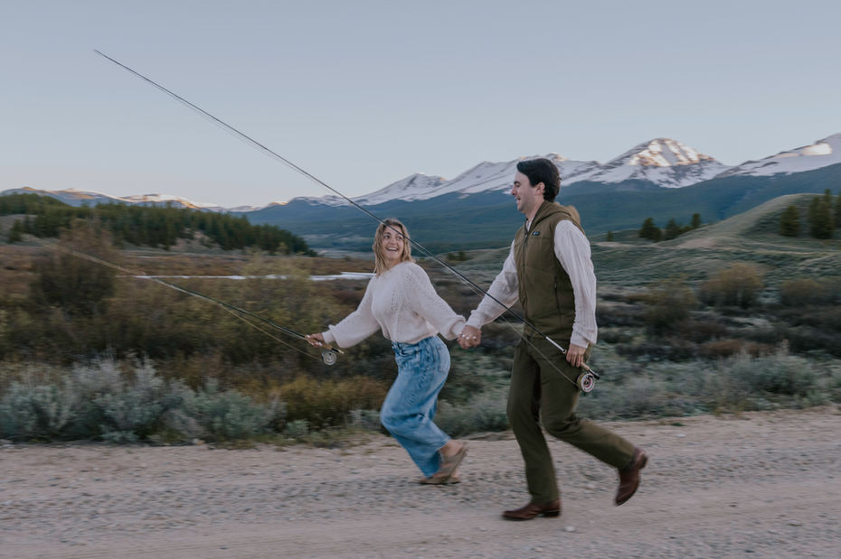 couple fly fishing photos with mountains in crested butte colorado