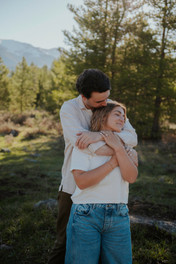 adventurous couple hugging and having their photo taken by jacey kate photography near crested butte colorado