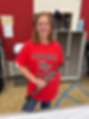 HF alum Jen Bilinski smiles at the camera, wearing a red Alumni Reunion t-shirt and holding a clarinet.