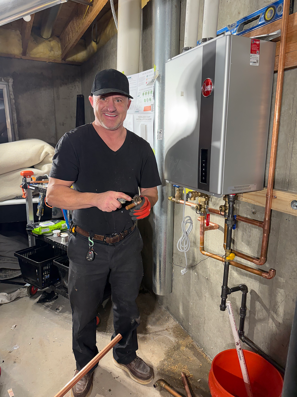 David of Unique Handyman Services working on a tankless water heater