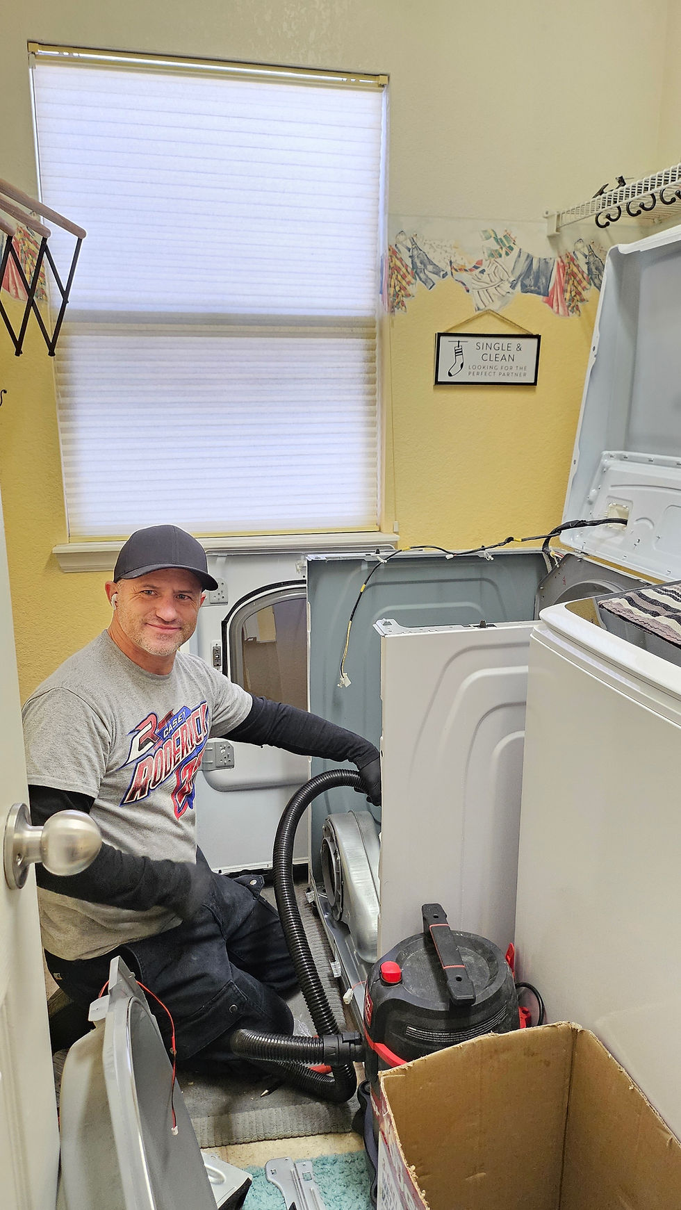 David of Unique Handyman Services repairing and cleaning out a clothes dryer
