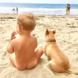 Baby in diaper free elimination communication journey at beach