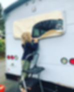 Pulling off the masking from the bus after painting