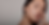 A young woman with bright, smooth skin gazing confidently into the mirror post-treatment.