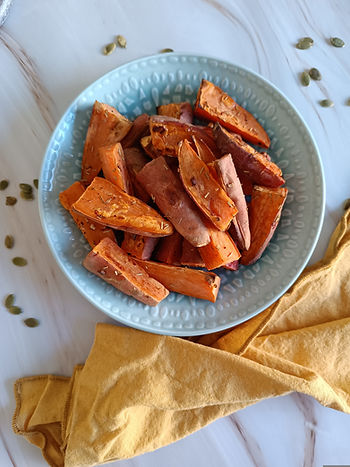 Marble counter, bird's eye view of a sweet potato wedges sitting in a pale green bowl