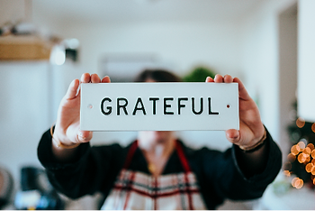 person holding a grateful sign