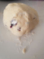 Cookie dough kneaded into a ball sits on counter